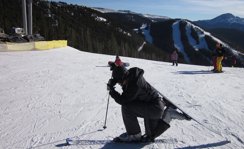 Caleb does a 'prayer pose' at the top of a ski run.