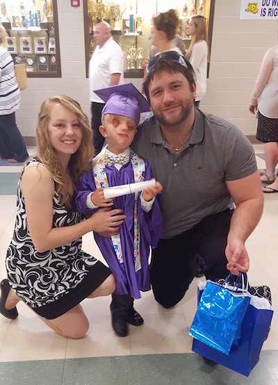 Lacey Buchanan with her husband and son, Christian, during his kindergarten graduation.