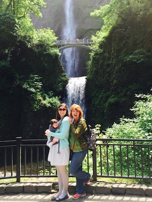 Cheryl Karpen poses with family in front of a waterfall.
