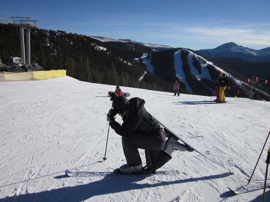 Caleb poses at the top of a ski run.