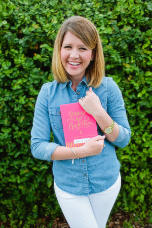 Emily Ley posing with her new book, Grace Not Perfection.