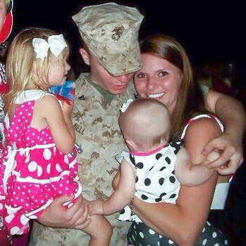 Zachary Bell with his wife and two daughters