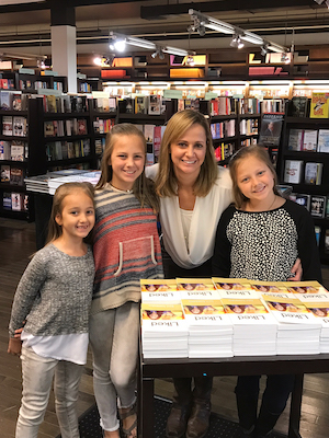 Kari Kampakis and her daughters with copies of Liked.