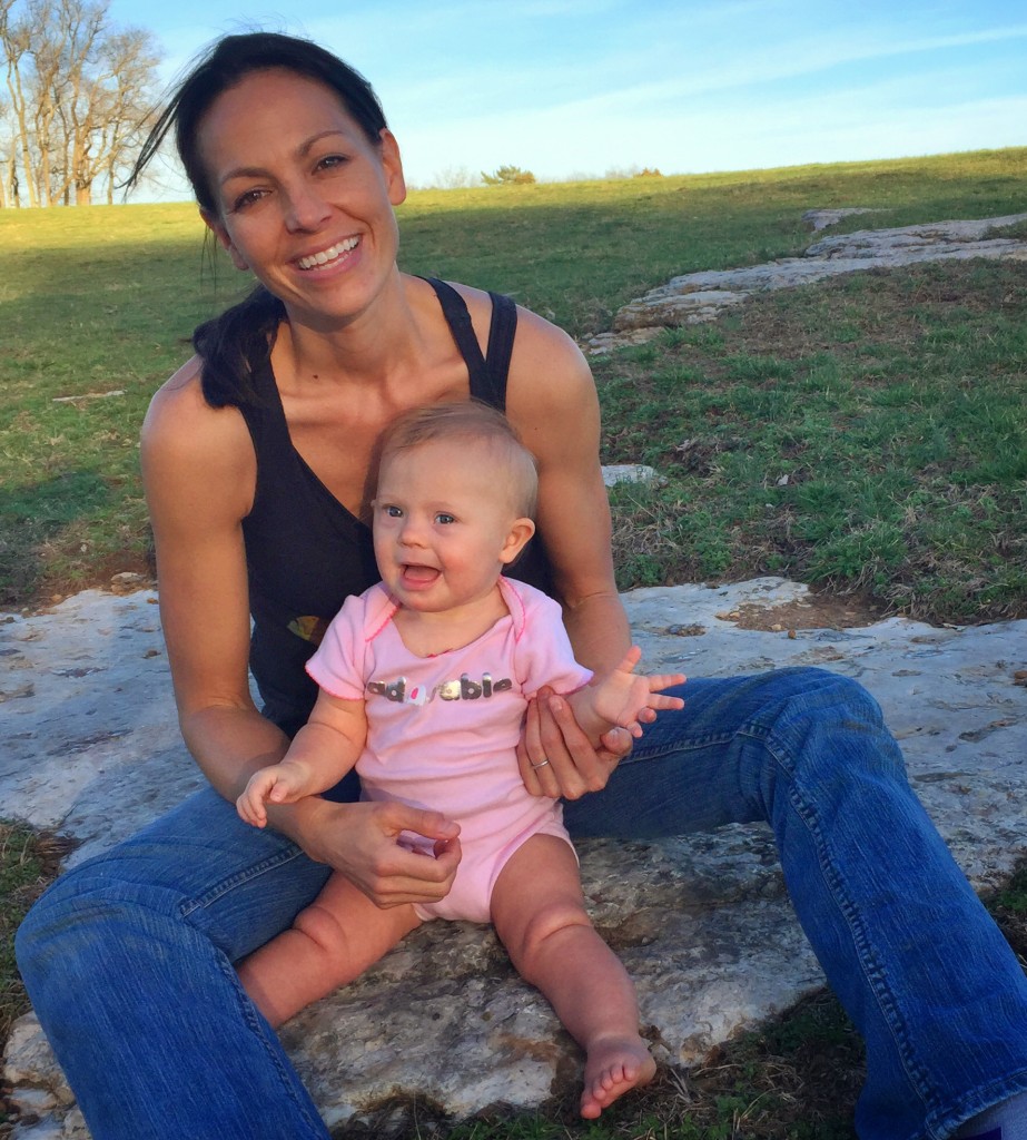 Joey sits in a park with her daughter, Indiana.