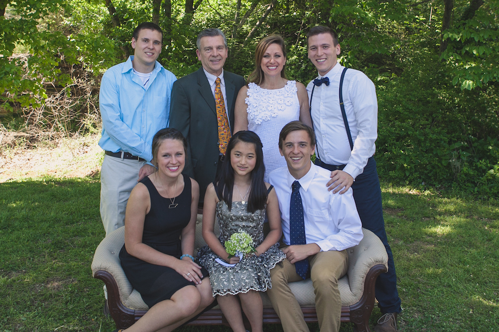 J.T. Olson poses for a picture with with wife and children.