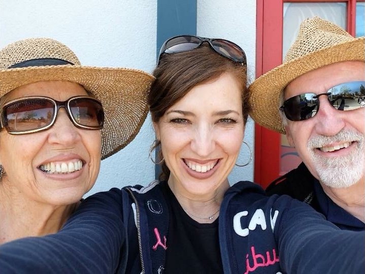 Maria-Jose Tennison takes a picture with her parents.