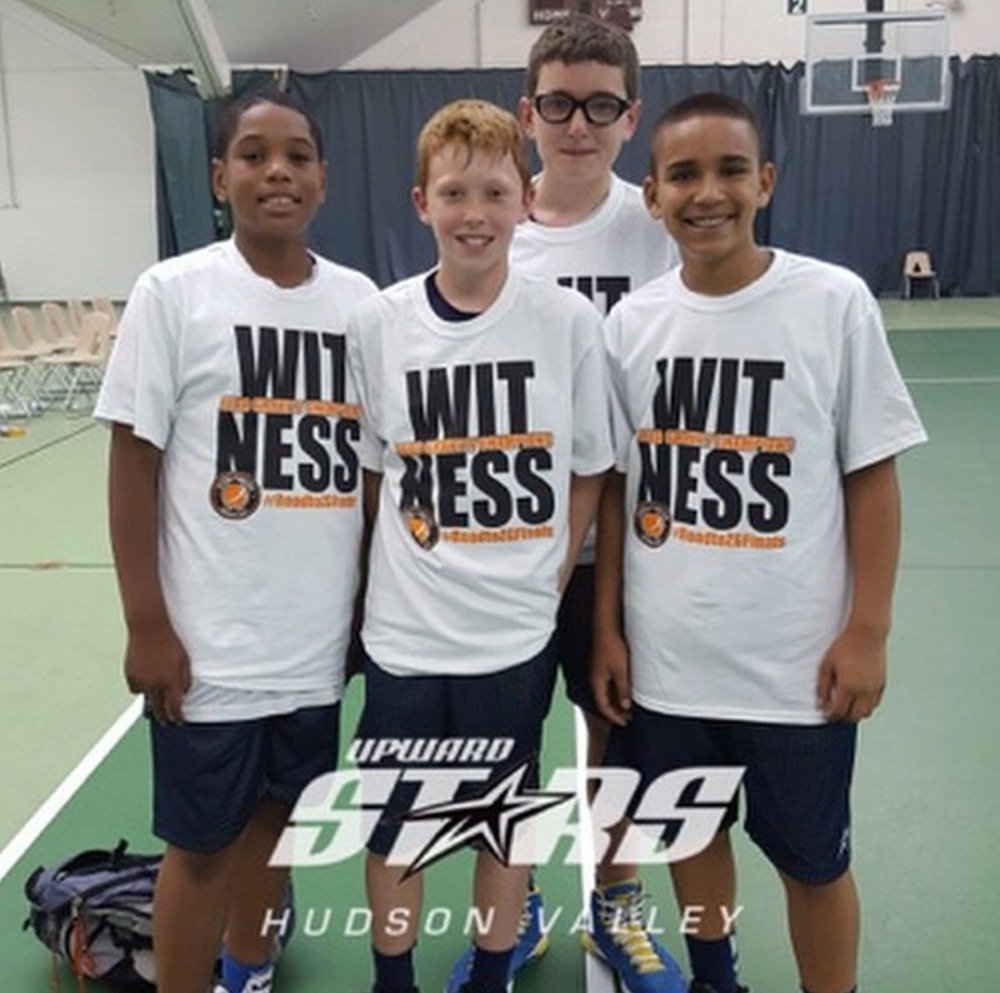 Four boys in the Upward Stars of Hudson Valley program pose for a photo.