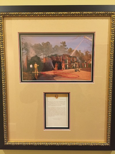 A photo and description of the burnt down house that was later rebuilt.