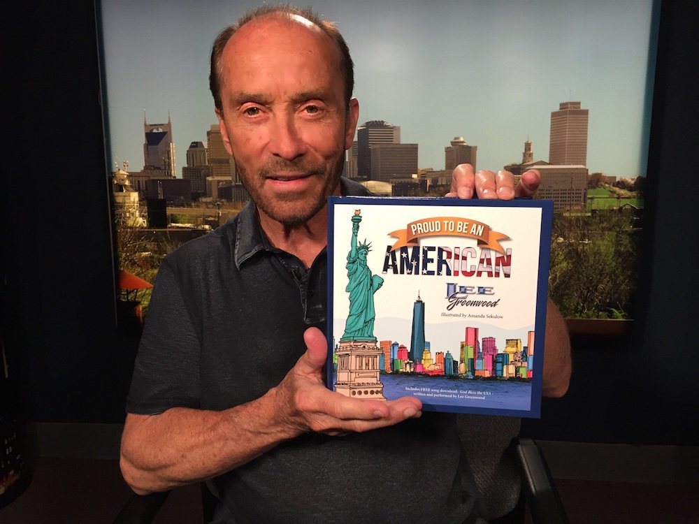 Lee Greenwood with his book, Proud to be an American.