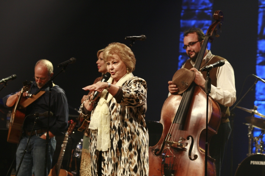 Gloria Gaithers performing on stage.