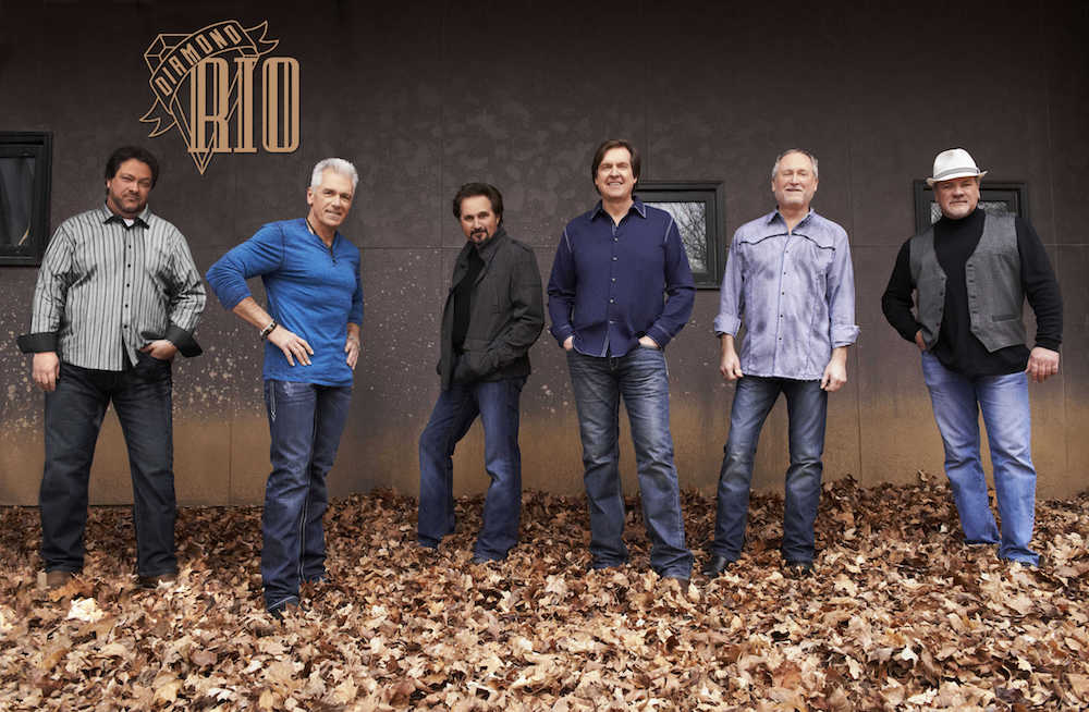 The members of Diamond Rio standing in some leaves.