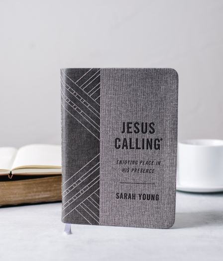 Jesus Calling gray edition on table with mug