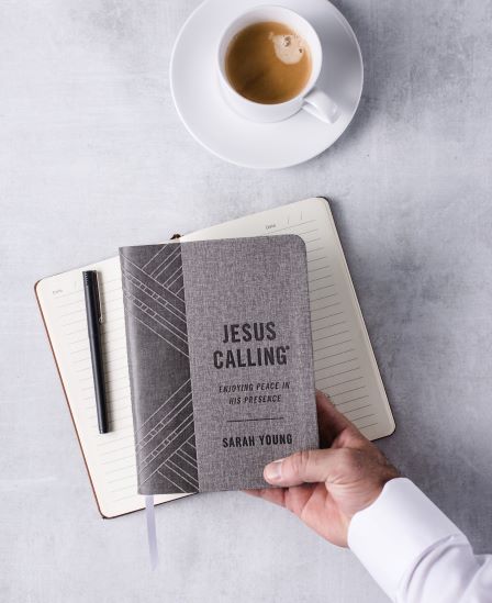 Jesus Calling Grey edition with hand holding the book