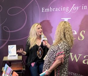 Hannah Anders visits the Jesus Calling booth at CMA Fest 2019