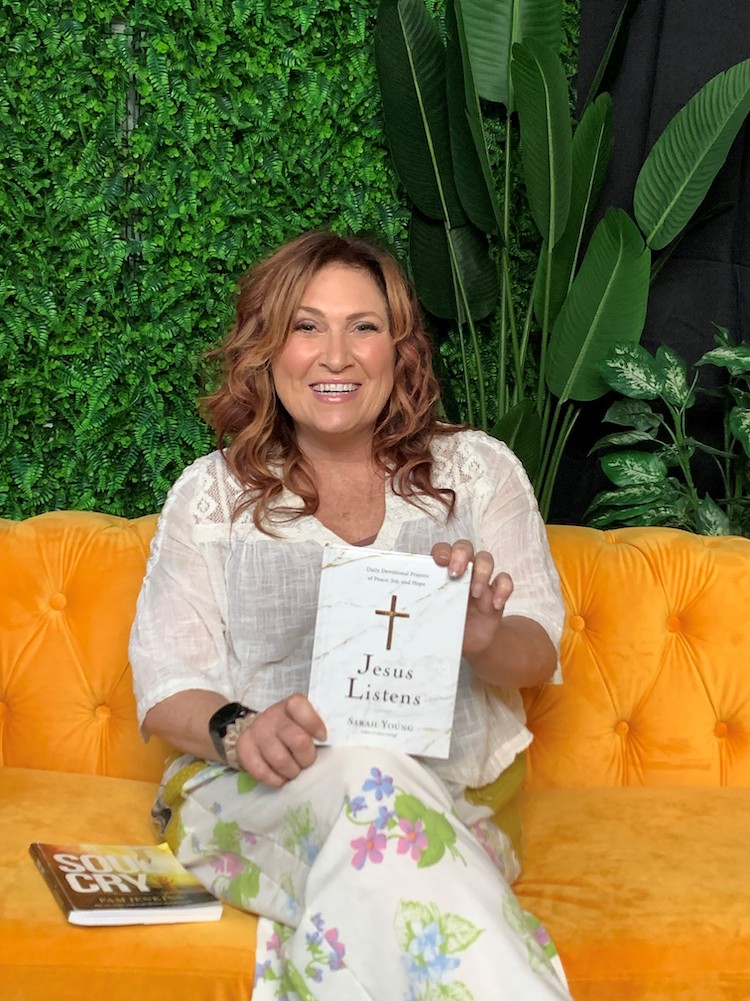 Jesus Calling 370 featuring Jo Dee Messina shown here holding a Jesus Listens devotional book