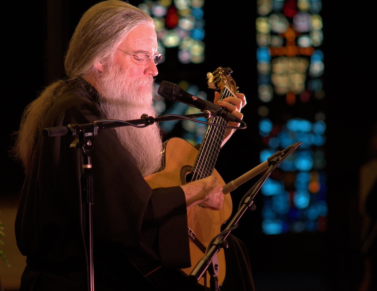 Jesus Calling podcast 417 featuring John Michael Talbot & John Andrew Bryant - shown here is Talbot playing guitar - JMT-Stained Glass PC Courtesy of John Michael Talbot