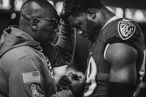 Jesus Calling podcast 446 featuring NFL Team Chaplains Kent Chevalier and Johnny Shelton & Pastor Earl McClellan - Johnny shown here during Pregame Prayer-Odafe Oweh PC Shawn Hubbard-Baltimore Ravens