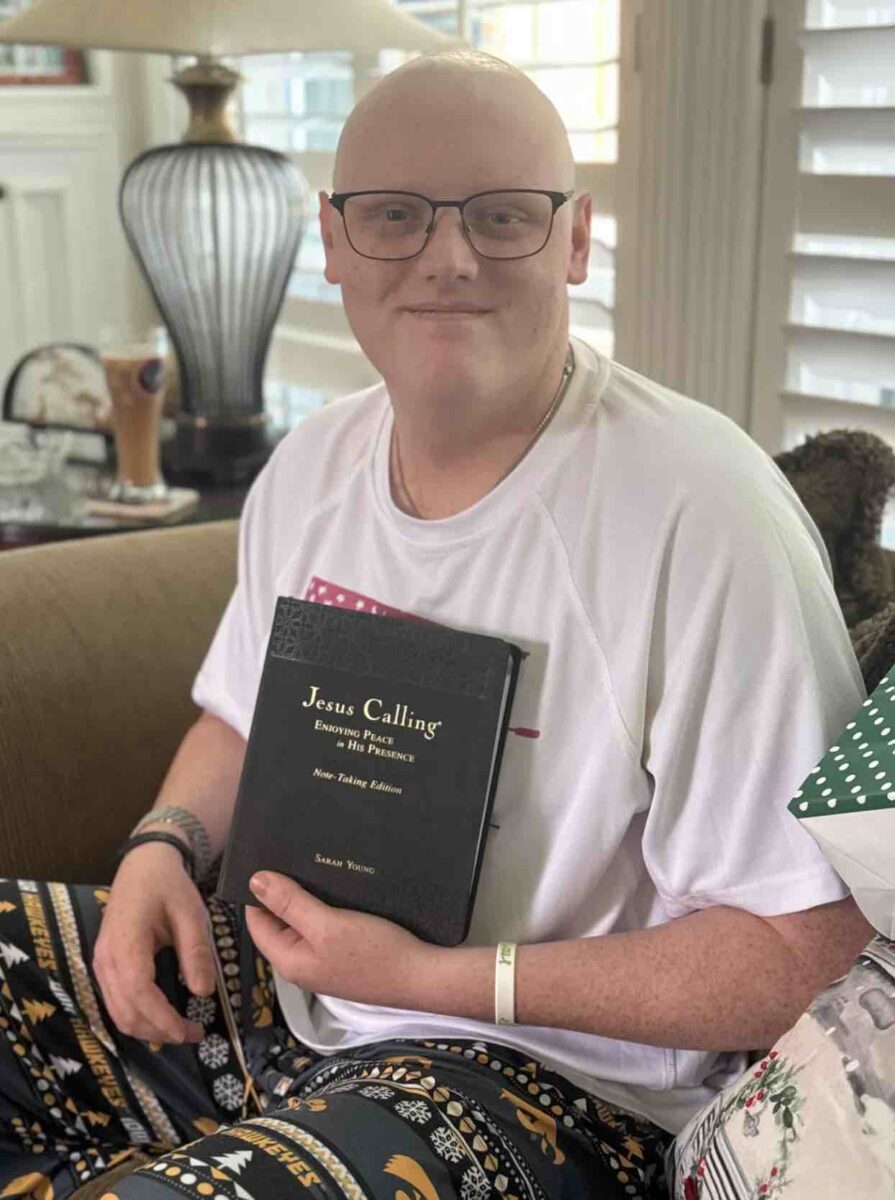 Jesus Calling podcast 462 featuring Cole Prasse - holding a copy of Jesus Calling while in the hospital