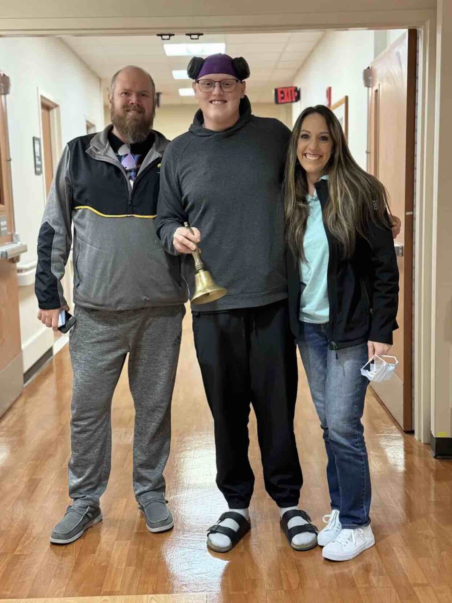 Jesus Calling podcast 462 featuring Cole Prasse - shown with his father and mother ringing the bell into cancer remission