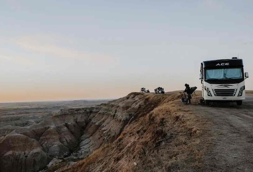 Jesus Calling podcast 475 featuring Dan and Sam Mathews - shown here is a parked RV with silhouette of a person in a chair overlooking a canyon
