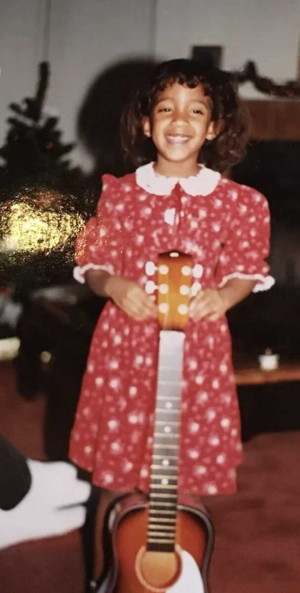 Jesus Calling podcast 475 featuring Mickey Guyton - shown as a young girl holding a guitar